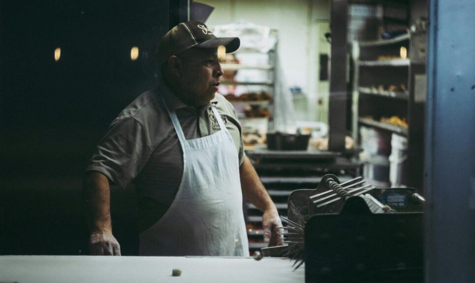 man wearing white apron