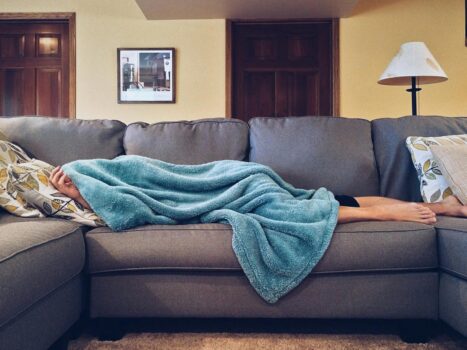 person lying on sofa